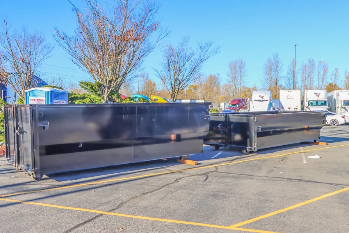 Professional dumpster rental service with roll-off container on residential driveway in Simpsonville